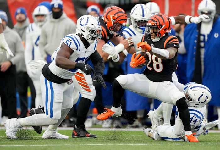Dec 10, 2023; Cincinnati, Ohio, USA; Cincinnati Bengals running back Joe Mixon (28) looks to advance the ball past Indianapolis Colts defensive end Kwity Paye (51) at Paycor Stadium. Mandatory Credit: Bob Scheer-USA TODAY Sports